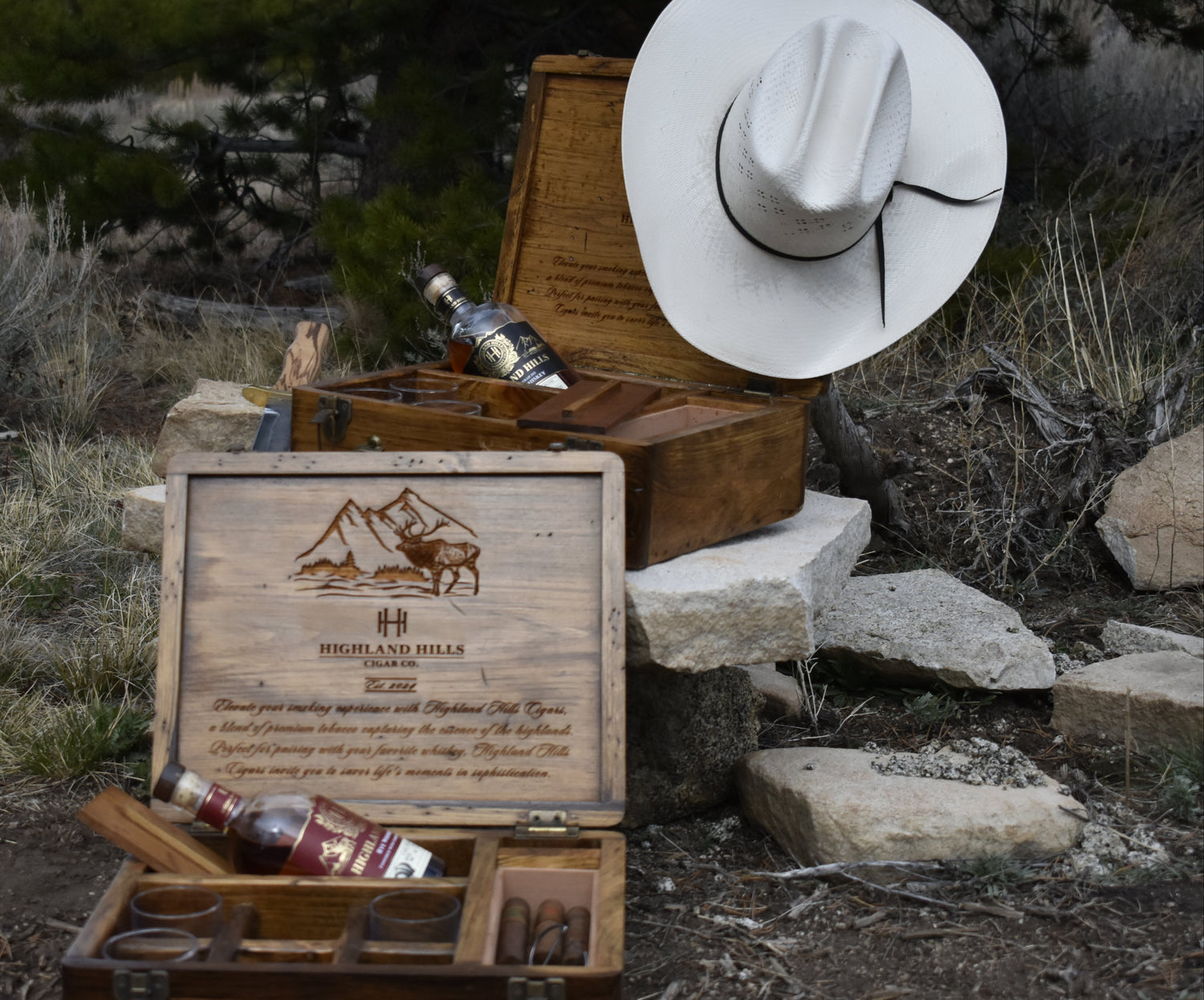 Highland Hills Cigars Cigar box with lid, surrounded by desert landscape.